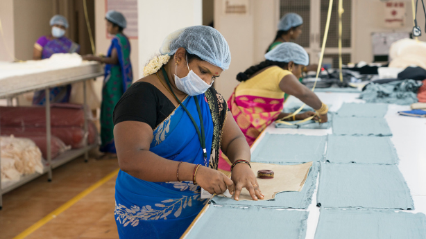 connoisseur-fashion-fair-trade-factory-worker-measuring-cloth