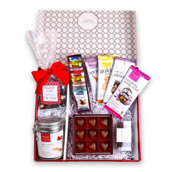 A Valentine's Day themed gift box from Chuao Chocolate that features passionate heart bonbons, dark chocolate seashells, tart cherry and hazelnut bark, and spicy maya hot chocolate.