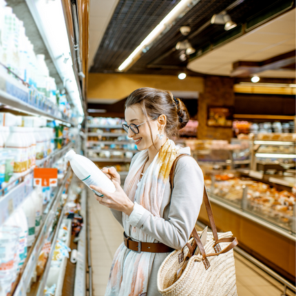Shopper looking at milk and dairy products in store Shopper looking at milk and dairy products in store