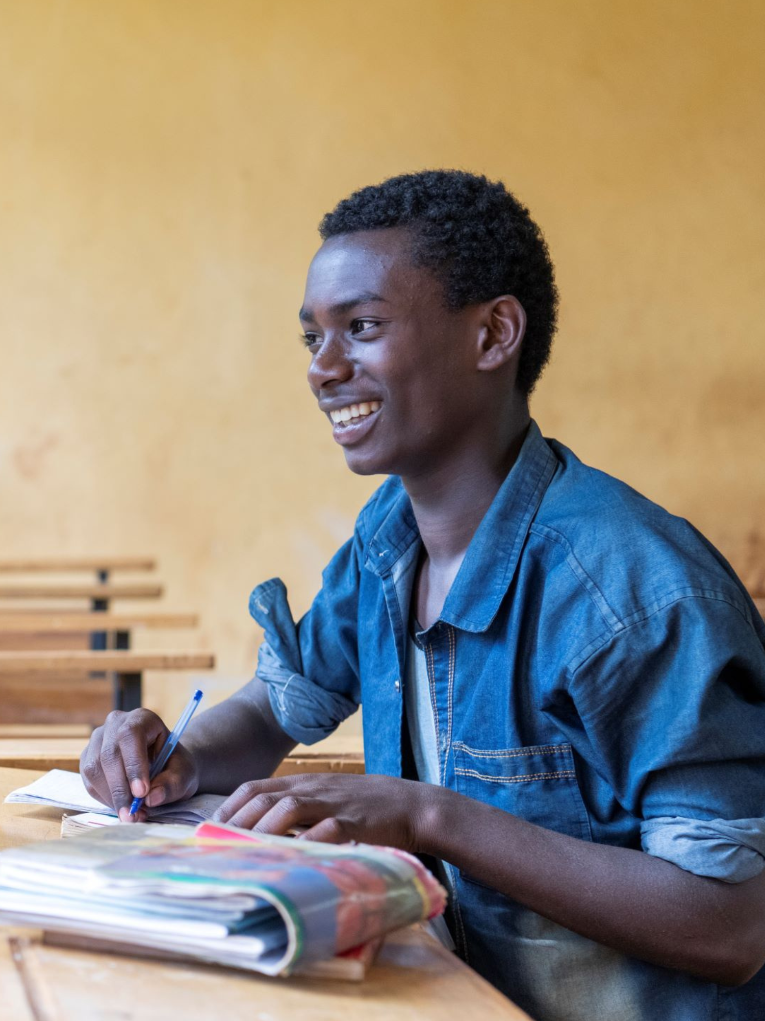 Estudiante sentado en una mesa en una escuela en Sidama, Etiopía