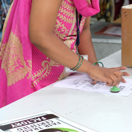 a factory worker submitting their vote for how to use Fair Trade Certified Community Development Funds