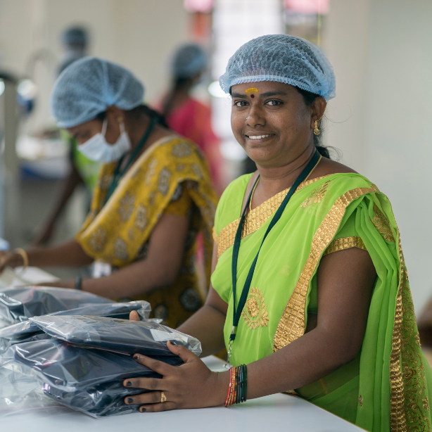 Workers pack materials for clothing products at Connoisseur Fashions, a Fair Trade Certified Factory in India.