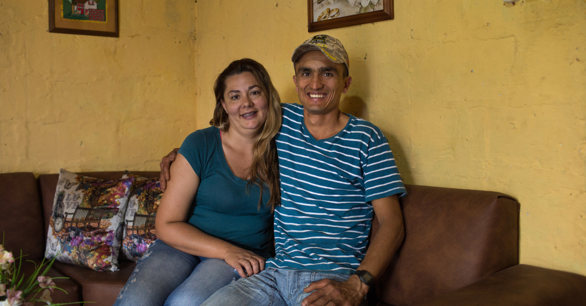 Arcangel de Jesus Restrepo Arroyave (right), poses for a photo inside his home along with wife Dovanelcy Ramirez Rivas.