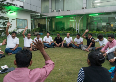 Workers and management have a Fair Trade committee meeting outdoors in the courtyard garden at the Rajlakshmi Cotton Mills in Howrah.